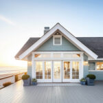 Modern single family home with large windows and landscaped front yard at sunset