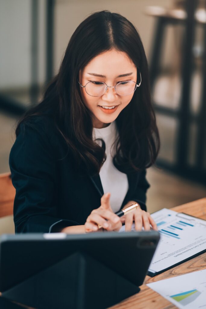 San Diego Real Estate Market Review San Diego real estate professional reviewing housing market reports, pricing trends, and property data on a tablet.